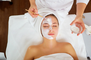 Woman in mask on face in spa beauty salon.