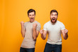 © Drobot Dean - Portrait of a two satisfied young men celebrating