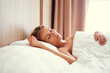 © Loginova - Sleepy beauty. Attractive young woman is sleeping at her bed.