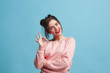 © master1305 - The happy business woman standing and smiling against blue background with sign ok.