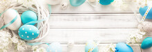 Easter Decoration With Eggs And Flowers On White Wooden Background