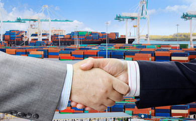 Aufkleber - Closeup of business people handshake on container terminal with cranes background 