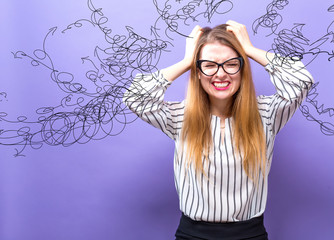 Wall Mural - Confused young business woman feeling stressed on a purple background