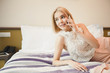 © Prostock-studio - Happy businesswoman lying in the hotel room