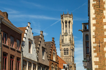 Wall Mural - Red brick houses and Belfry tower. Typical street with medieval Flemish architecture of Bruges, Belgium.