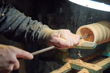 A man in the Studio hones wood blanks on a woodworking machine. turning wood on a lathe