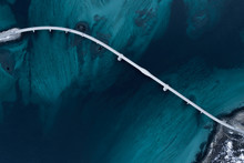 Aerial Shot Of A Bridge Over Sea Strait. Visible Depth With Blue And Green Colours Near Tromso. Sommaroy, Norway