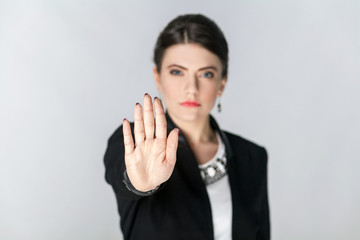 Wall Mural - Focus on hand. Seriously woman showing stop hand sign