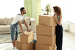 © ASDF - Happy and young couple looking at boxes