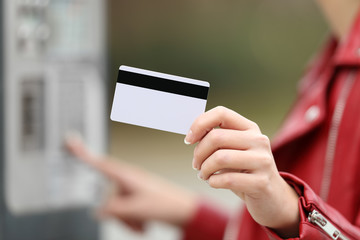 Wall Mural - Woman using a credit card to pay in a payment machine