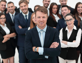 Sticker - happy businessman standing on background of her business team.