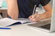 © Africa Studio - Teenager boy doing homework indoors, closeup