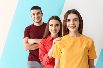 Wall Mural - Young people posing together on color background. Unity concept