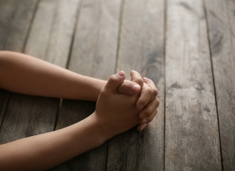 Little boy praying at table, closeup