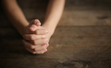 Wall Mural - Little boy praying at table, closeup