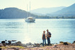 © luengo_ua - Travel and tourism. Senior family couple standing together on Mediterranean sea beach.