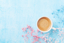 Morning Cup Of Coffee And Colorful Flowers On Blue Pastel Table Top View. Flat Lay Style. Creative Breakfast For Woman Day.