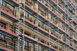 Fototapeta  - scaffolding around the house - historical building facade renovation
