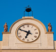 clock with decorations and statue on the civic building