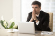 © fizkes - Worried company leader thinking about problem solution, pondering important question, frustrated because of difficulties in business while sitting at desk. Religious businessman praying at workplace