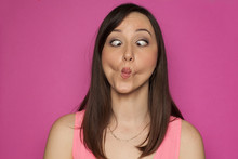 Young Funny Woman Making Silly Faces On Pink Background