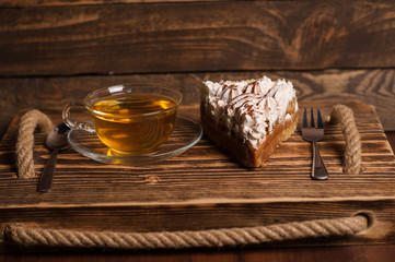 Wall Mural - cake with tea on wooden desk