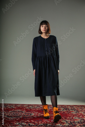 Portrait Of Young Woman With Short Dark Hair Dressed In Navy Blue