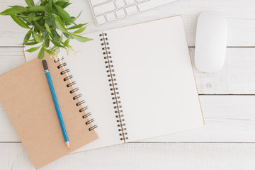 Wall Mural - empty open notebook on white wood table top view,flat lay photo of office desk with mouse and keyboa