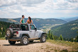 © Connect Images - Road trip couple in four wheel convertible in Rocky mountains, Breckenridge, Colorado, USA