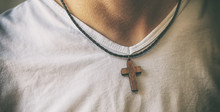 The Wooden Cross Necklace On Man's Neck