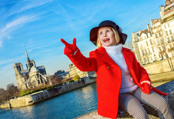 child on embankment near Notre Dame de Paris in Paris, France