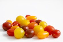Variety Of Plum, Grape, Cherry, Small Tomatoes With Red, Orange And Yellow Colors With Copy Space To Top