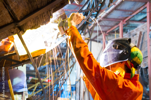 Fotomural Welder in process of old ship restoration