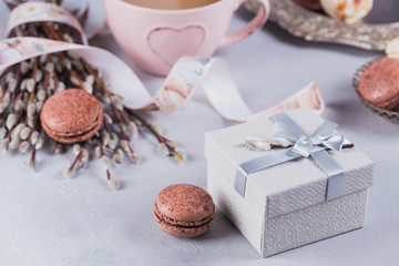 Wall Mural - Pink coffee mug with sweet pastel french macaroons, gift box and pussy willow