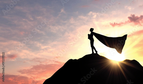 Cuadros en Lienzo Silhouette of a superhero business woman wearing a cape against a bright sky