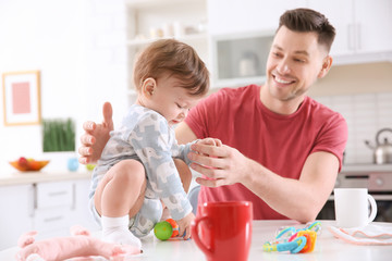 Canvas Print - Father playing with his little son in kitchen