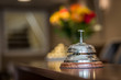 hotel service bell on front desk reception with blurred bokeh background