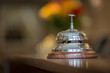 hotel service bell on front desk reception with blurred bokeh background