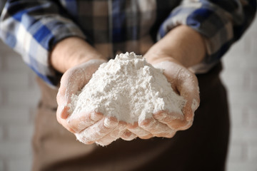 Man holding wheat flour, closeup