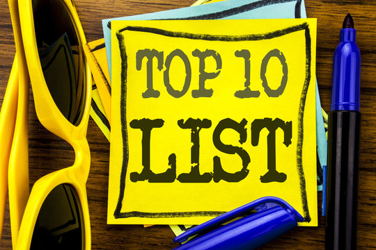 Hand writing text caption inspiration showing Top 10 Ten List. Business concept for Success ten list Written on sticky note paper, wooden background with vacation sunglasses and bold marker