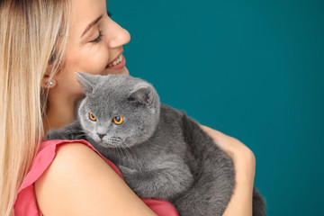 Wall Mural - Young woman with cute pet cat, closeup