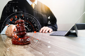 Poster - justice and law concept.Male judge in a courtroom with the gavel,working with smart phone,digital tablet computer docking keyboard,eyeglasses,on wood table