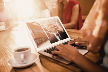 Poster - composite image of businesswoman working on laptop at office