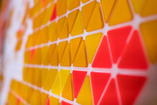 Tessellation Of A Plane With Yellow, Orange And Red Colored Triangles On A White Background. Mathematical And Artistic Game To Cover A Surface With Geometric Shapes. Triangles In Sequence As A Code