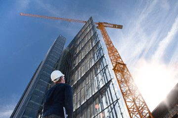 architect engineer on construction site inspecting building