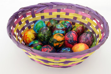 Easter eggs. Handmade painted eggs in basket for Easter celebration isolated on white background. Easter. Colored Easter eggs. Colorful egg. Copy space. Text space. Unique handmade painted eggs