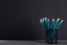 Pencils In Metal Holder Pot In Front Of Wall Background