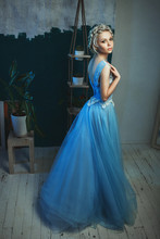 Beautiful Model Wearing Light Blue Dress Is Posing In A Studio 