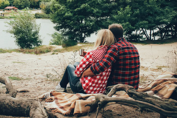 a love couple on the picnic near the river with tea