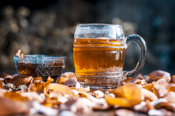 Popular Indian/Asian summer drink i.e NAM MANGLAK or Sweet basil drink consisting of rose syrup,sweet basil and honey with sugar on a wooden surface in Gothic colors.